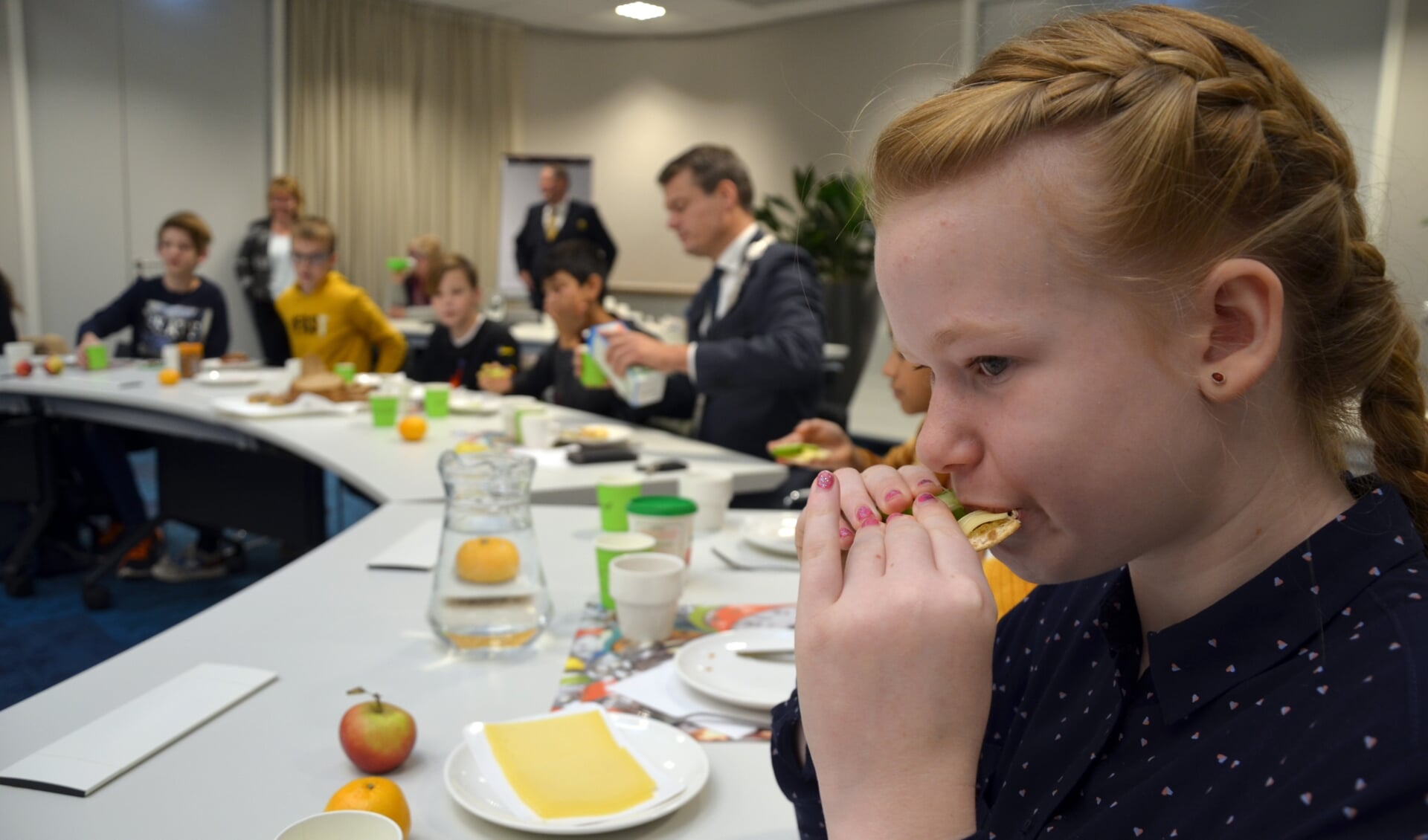 De 11-jarige Jaymee Joore geniet van een cracker met kaas in het gemeentehuis. (foto en tekst: Nicole Lamers)