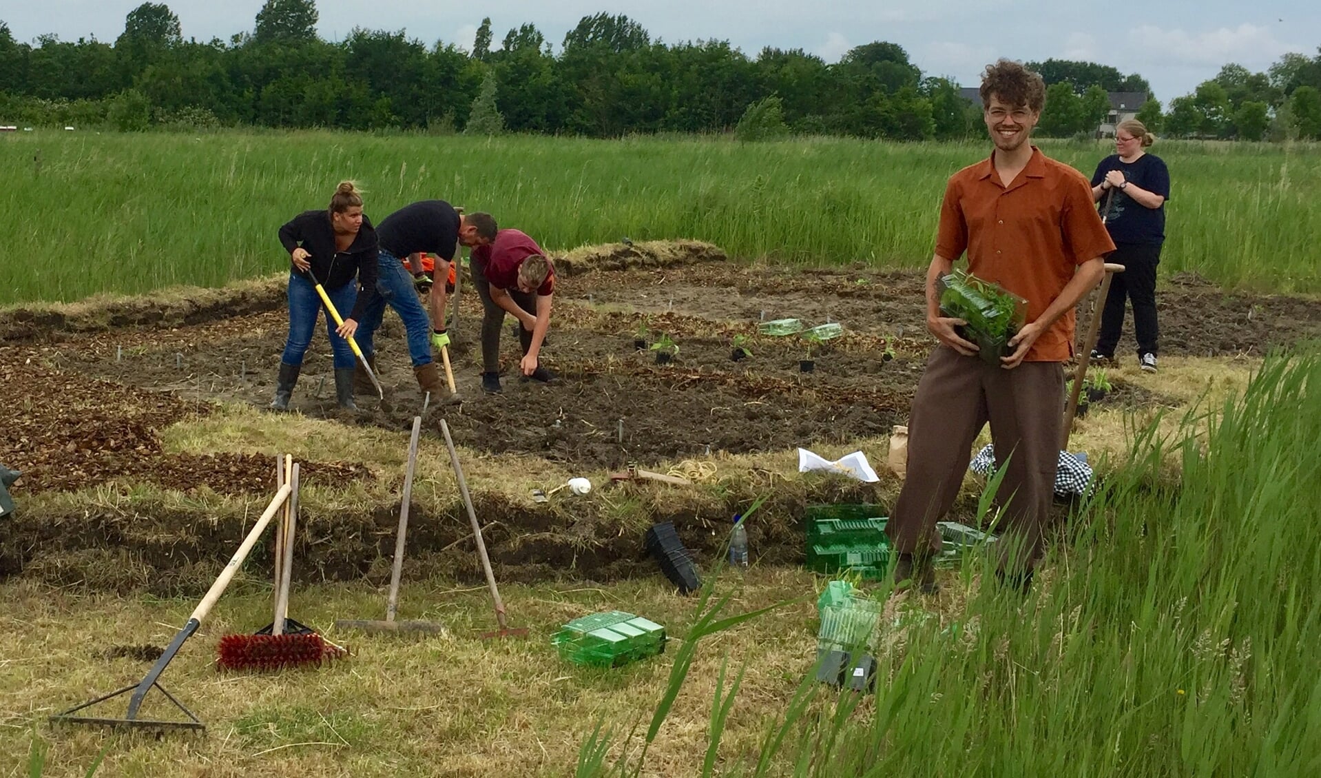 Cliënten van Zorghoeve Kakelbont helpen de proeftuin aanleggen. Vooraan rechts Michael den Boer.