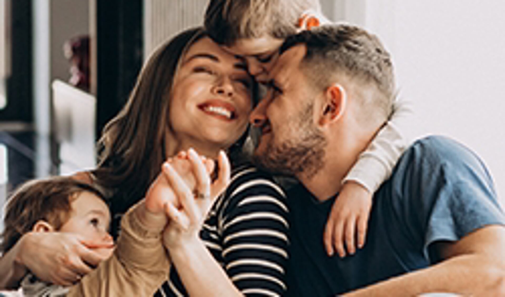 Young family with their sons at home having fun