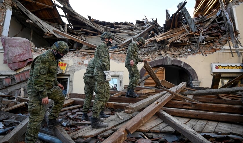 Soldaten zoeken in Petrinja tussen het puin naar overlevenden van de aardbeving. De regio bij Zagreb is getroffen door een zware beving. (beeld afp / Denis Lovrovic)