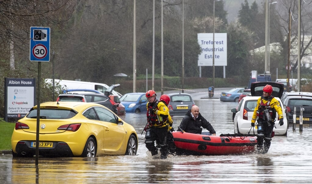 Hulpdiensten evacueren mensen in Nantgarw, een dorp in Zuid-Wales, na storm Dennis, die zondag over het land trok. (beeld epa / Neil Munns)