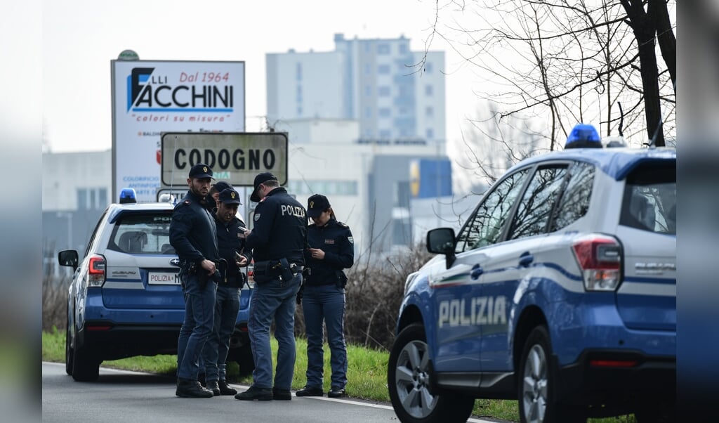 Agenten blokkeren de weg aan de rand van Codogno. Verschillende Italiaanse stadjes zijn in quarantaine geplaatst vanwege het coronavirus. (beeld afp / Miguel Medina)
