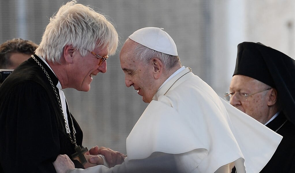 Paus Franciscus spreekt met de Duitse lutherse bisschop Heinrich Bedford-Strohm (links) terwijl de oosters-orthodoxe patriarch Bartholomeüs I toekijkt. De ontmoeting vond plaats op 7 oktober tijdens een vredesontmoeting van de gemeenschap van Sant'Egidio bij het Colosseum in Rome. (beeld afp / Filippo Monteforte)