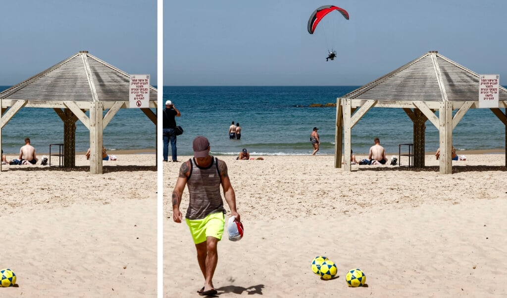 A paraglider flies above a beach in Israel's Mediterranean coastal city of Tel Aviv on April 7, 2021.
JACK GUEZ / AFP (beeld JACK GUEZ)