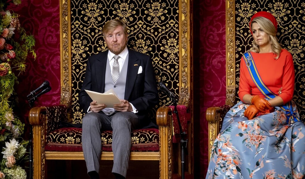 Koning Willem-Alexander leest op Prinsjesdag de Troonrede voor aan leden van de Eerste en Tweede Kamer in de Grote Kerk. Naast hem koningin Maxima. Normaliter wordt de Troonrede in de Ridderzaal uitgesproken, maar omdat vanwege corona meer ruimte nodig was, werd voor het tweede jaar op rij uitgeweken naar deze locatie. (beeld anp / Koen van Weel)
