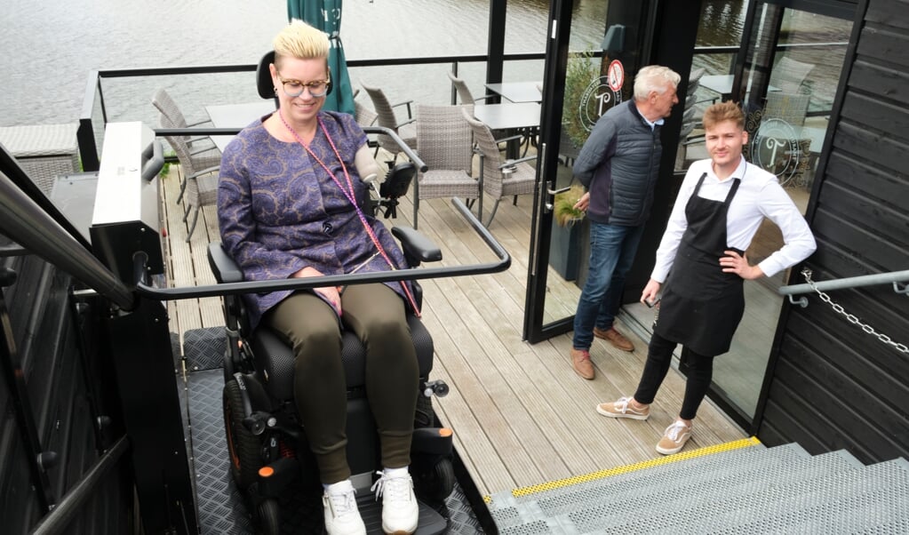 Via de rolstoellift kan Karin van der Haar de eerste verdieping van restaurant De Troubadour bereiken. (beeld Dick Vos)
