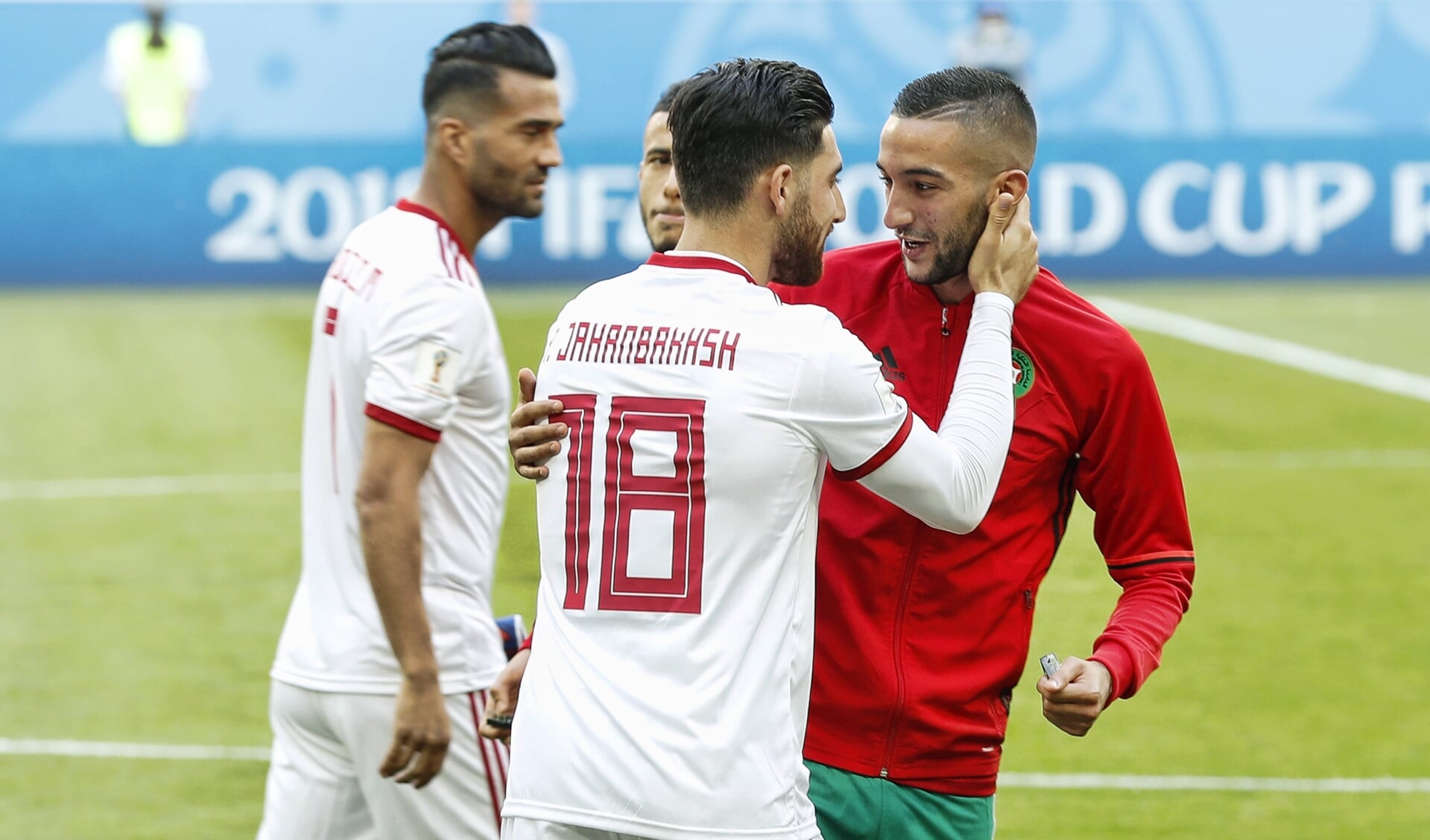 Middenvelder Hakim Ziyech (R) van Marokko begroet aanvaller Alireza Jahanbakhsh (L) van Iran voorafgaand aan de WK wedstrijd Marokko tegen Iran.