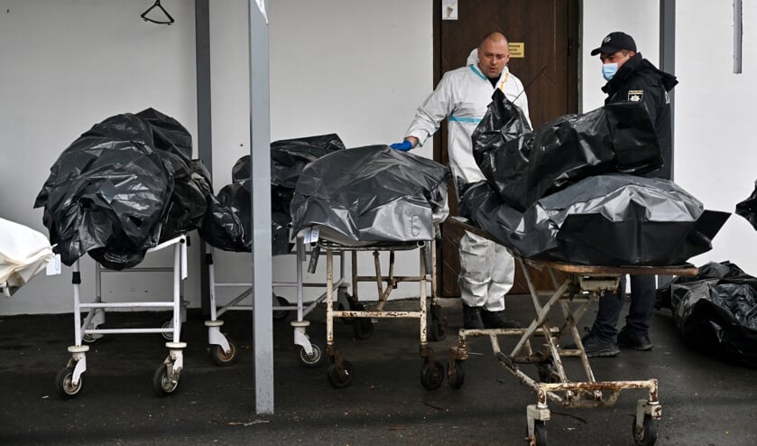 De mortuariums waren in Boetsja te klein de afgelopen maanden. Doden lagen in zwarte zakken naast de ingang op brancards.