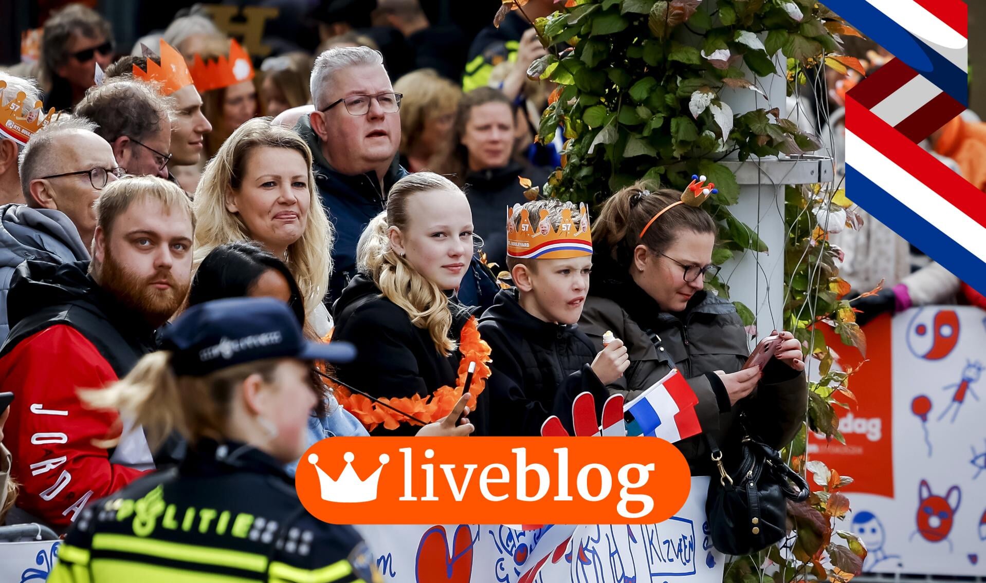 Oranjefans in Emmen wachten gespannen op de komst van de koninklijke familie.