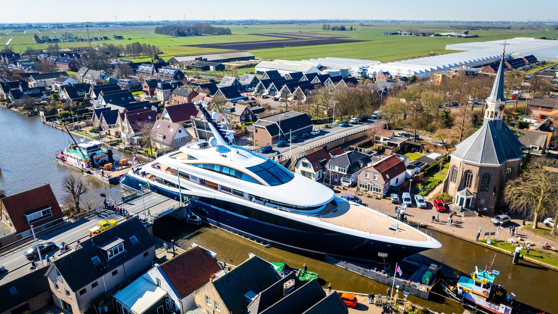 Het megajacht 'Faith' van Formule 1-baas Lawrence Stroll passeert Woubrugge, op weg vanaf de werf in Aalsmeer naar Rotterdam voor een eerste proefvaart.