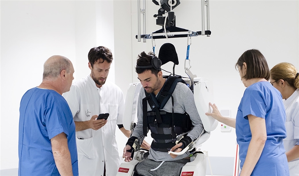 De verlamde Thibault in zijn exoskelet, omringd door medewerkers van het Clinatec laboratorium en de universiteit van Grenoble. (afp / clinatec endowment fund)