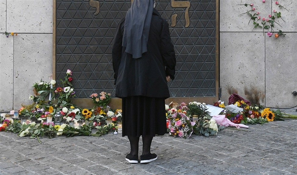 Een zuster gedenkt bij de ingang van de synagoge in de Duitse stad Halle de slachtoffers, een paar dagen na de aanslag. (afp / Christoph Stache)