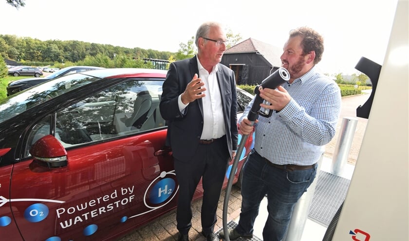 Thijs ten Brinck (r) staat bij de waterstofauto van Ad van Wijk. In zijn waterstofladder stelt hij voor om waterstof eerst voor andere toepassingen te gebruiken en dan pas voor personenvervoer. (William Hoogteyling)