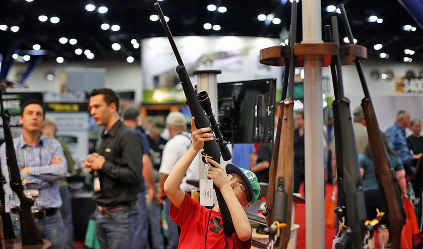 Een 11-jarige jongen inspecteert een wapen op een beurs van de machtige wapenlobby NRA in Houston in 2013. (ap / Todd Spoth)