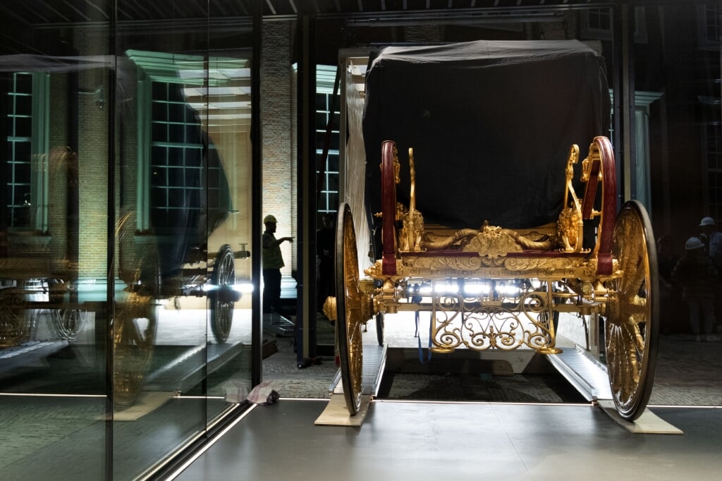 2021-06-10 03:03:36 AMSTERDAM - De Gouden Koets is met behulp van een hijskraan in het Amsterdam Museum geplaatst. De gerestaureerde Gouden Koets, die ruim 2.800 kilo weegt, is hier als middelpunt van een gelijknamige tentoonstelling acht maanden lang van dichtbij te zien voor publiek. ANP OLAF KRAAK (beeld anp / Olaf Kraak)
