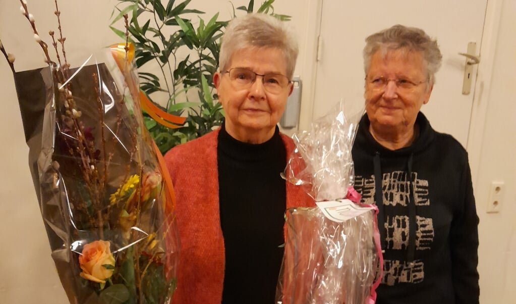 Katrien Dragt (links) werd tijdens de jaarvergadering in de bloemetjes gezet vanwege 50 jaar trouw lidmaatschap van Vrouwen van Nu. 