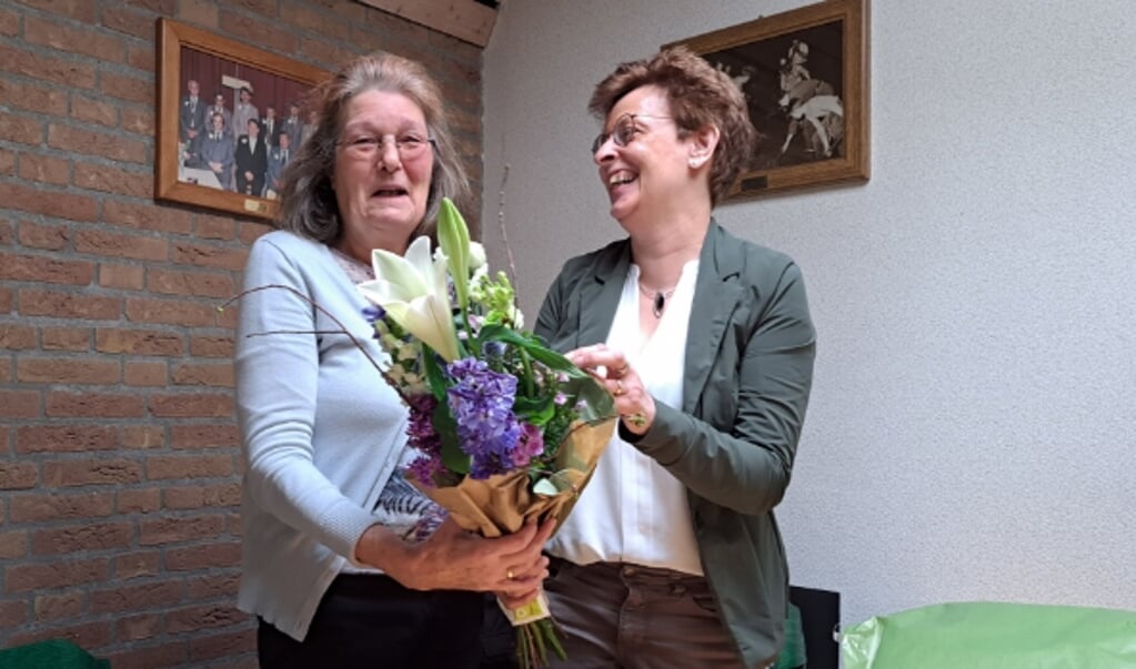 Jannie krijgt bloemen van directeur Rita van Tongeren.