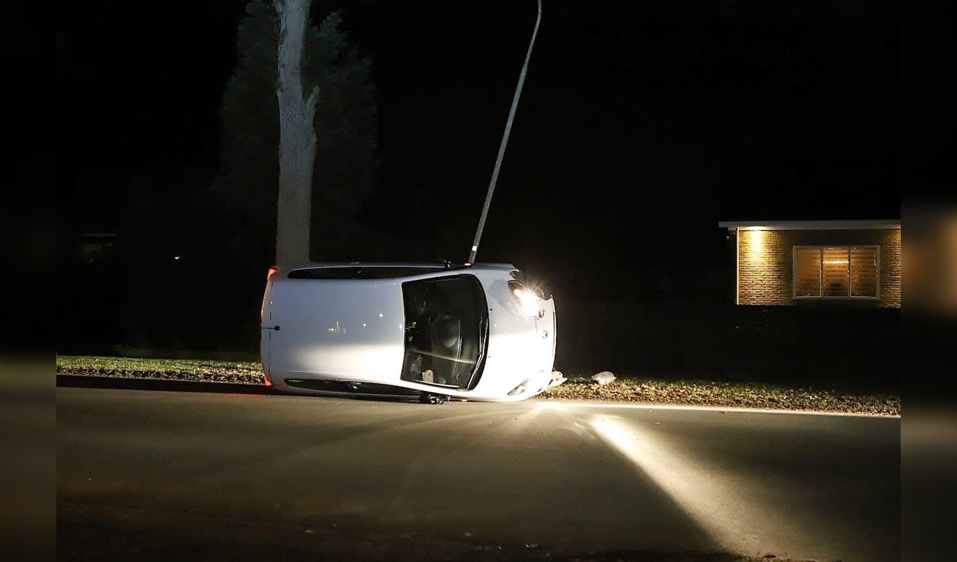 De auto kwam na de botsing met de lantaarnpaal op zijn kant terecht. (foto: Persbureau Drenthe)