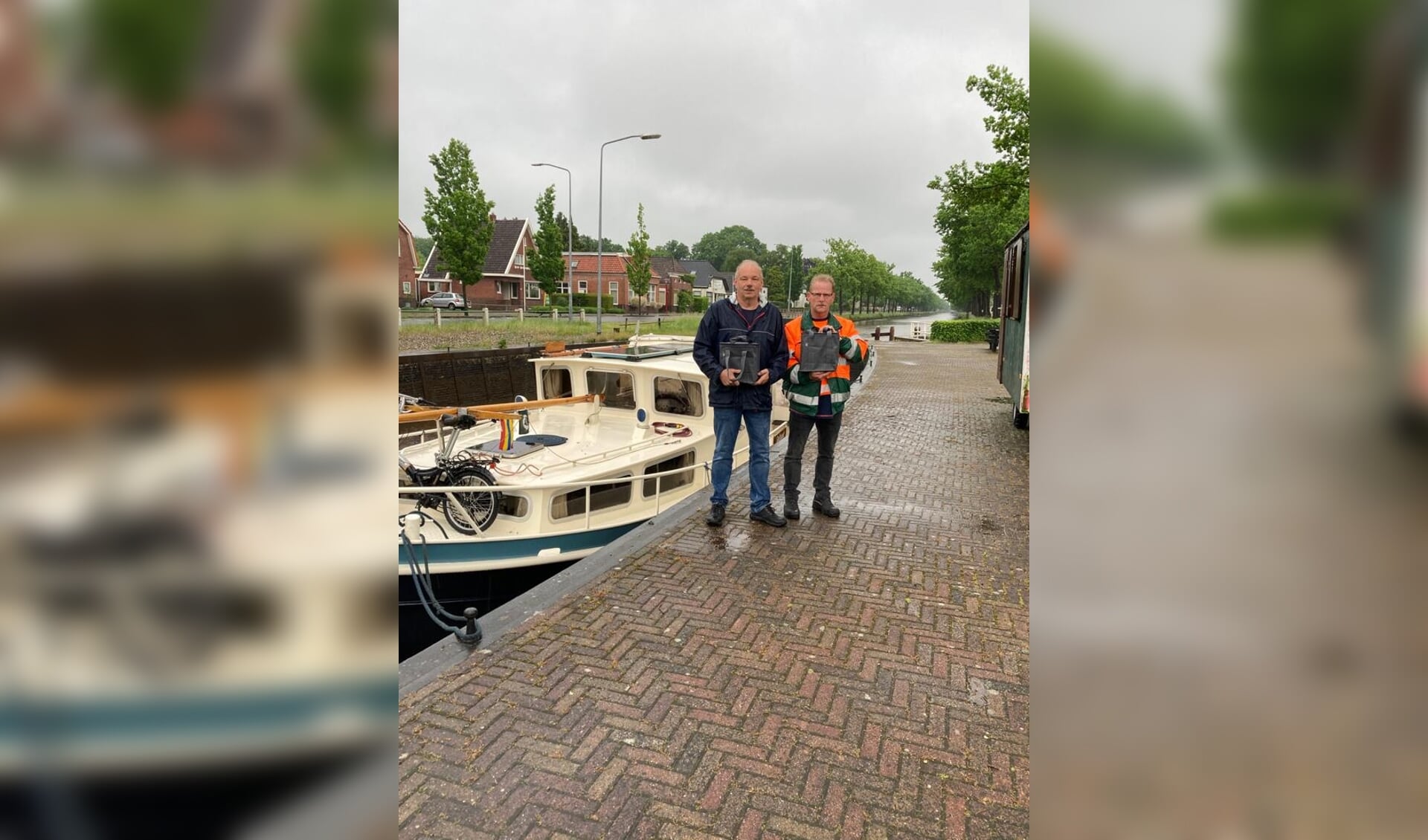 Jan Meertens en brugwachter Job Loots met de asbussen van Marinus en Hendrika Meertens. (eigen foto)