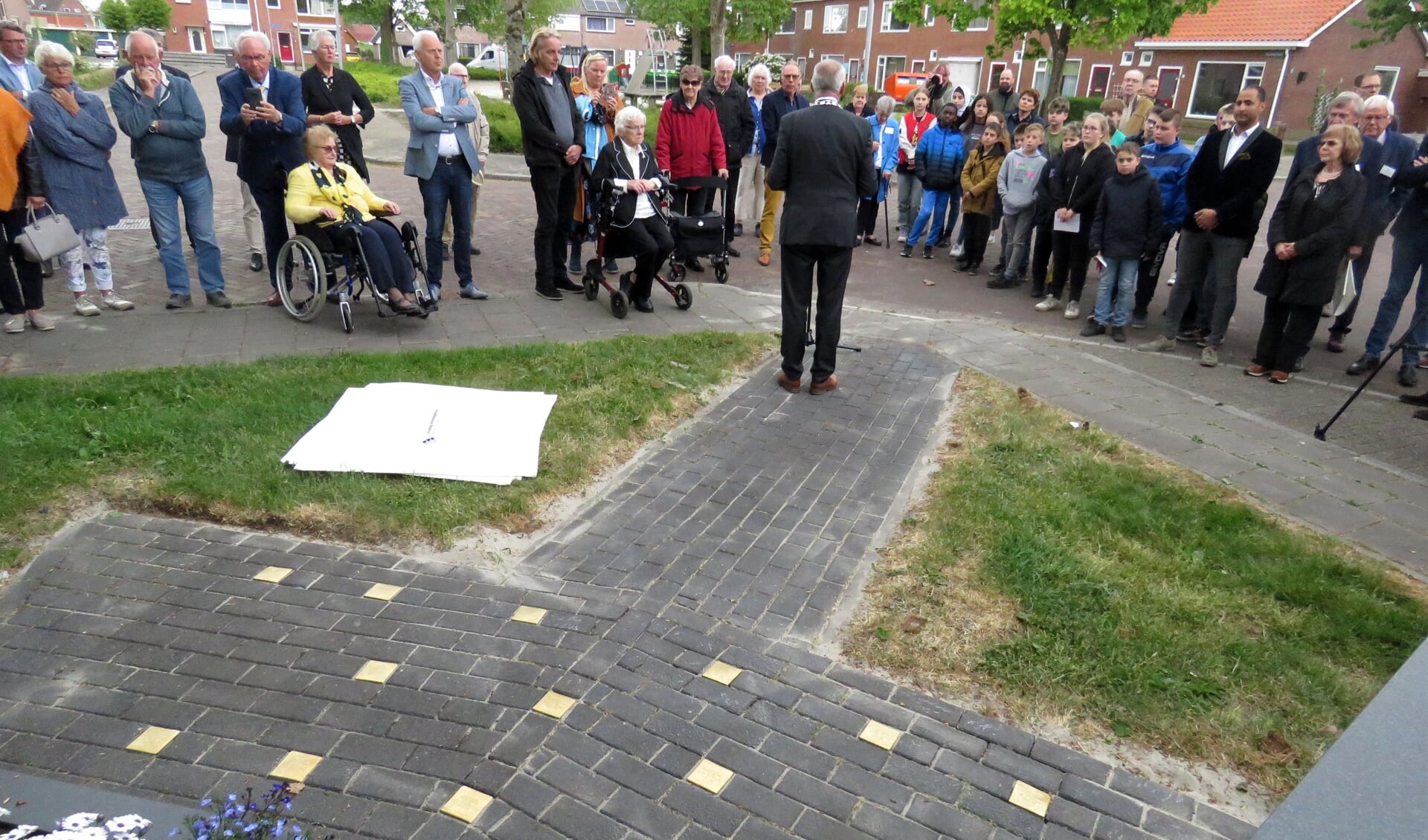 Burgemeester Hoogendoorn spreekt na de onthulling van de stenen de aanwezigen toe.