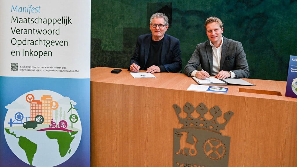 Wethouders Ploeger en Drenth ondertekenen het manifest. (foto: gemeente Midden-Groningen/Venema Media)
