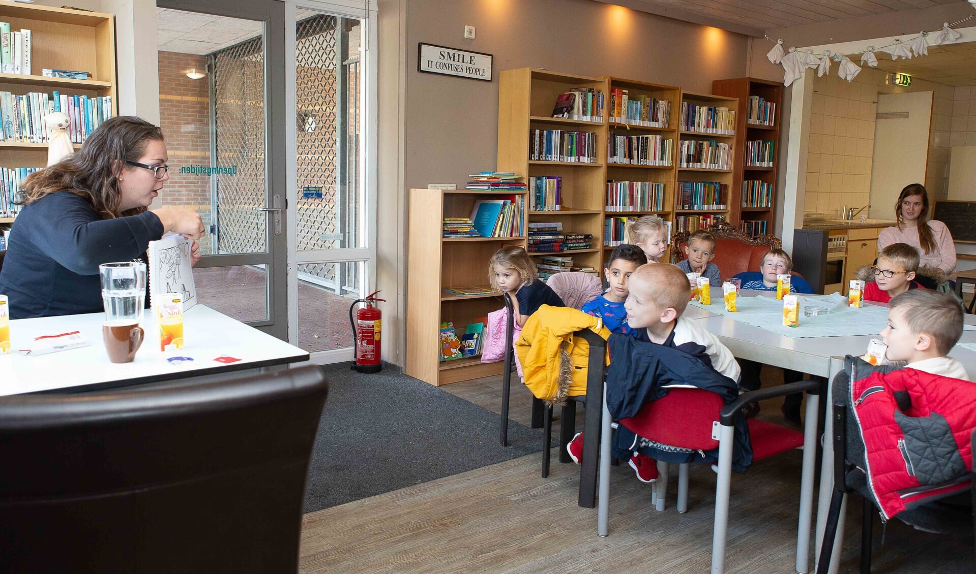 Laurianne Verhagen leest schoolkinderen voor in de bieb van 't Blickvelt.