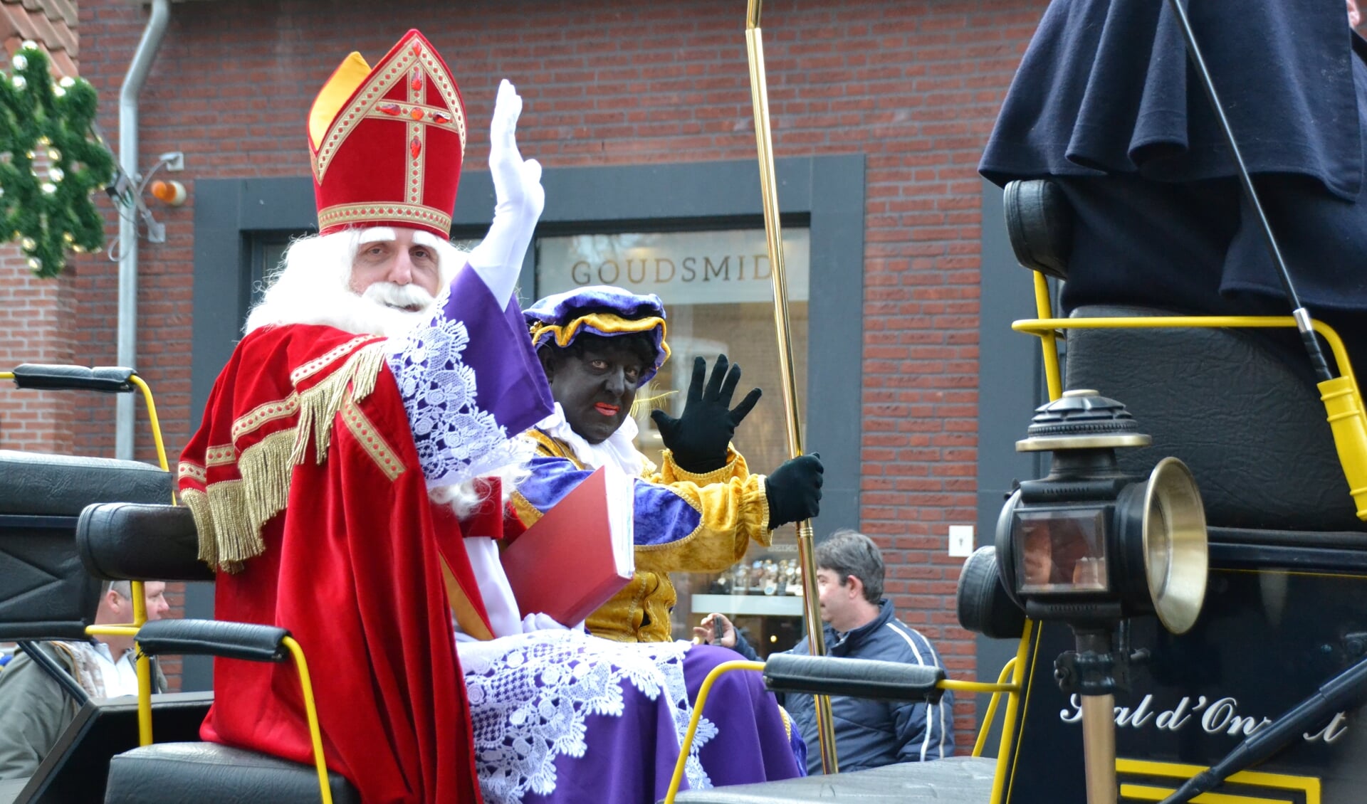 Sinterklaas en zijn hoofdpiet reageren enthousiast op de hartverwarmende ontvangst tijdens hun tocht door de Dorpsstraat.