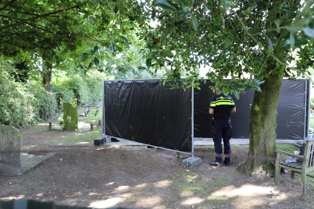 Op het kerkhof achter de Quirinuskerk in Halsteren wordt door forensisch deskundigen het lichaam van Mia Grinwis opgegraven.