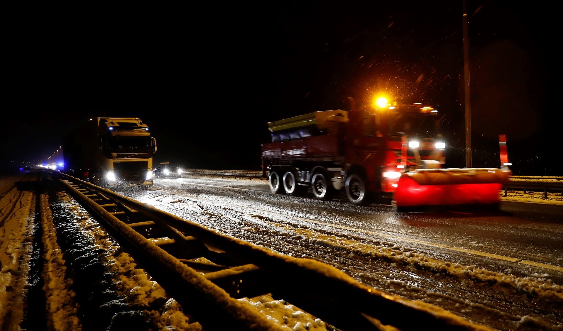 De slippende vrachtwagen 'parkeerde' zichzelf in de vangrail. 
Ondertussen reden strooi- en sneeuwschuifwagens af en aan. Foto: SK-Media