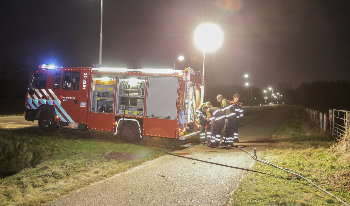 De brandweer moest de hooibalen uit elkaar trekken om bij de brand te komen ( Foto's : Maickel Keijzers / Hendriks Multimedia ) 
