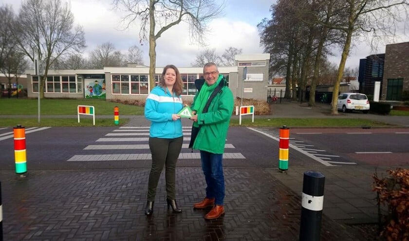 Maurits van den Bosch biedt de klik sticker aan aan Talitha de Graaf
