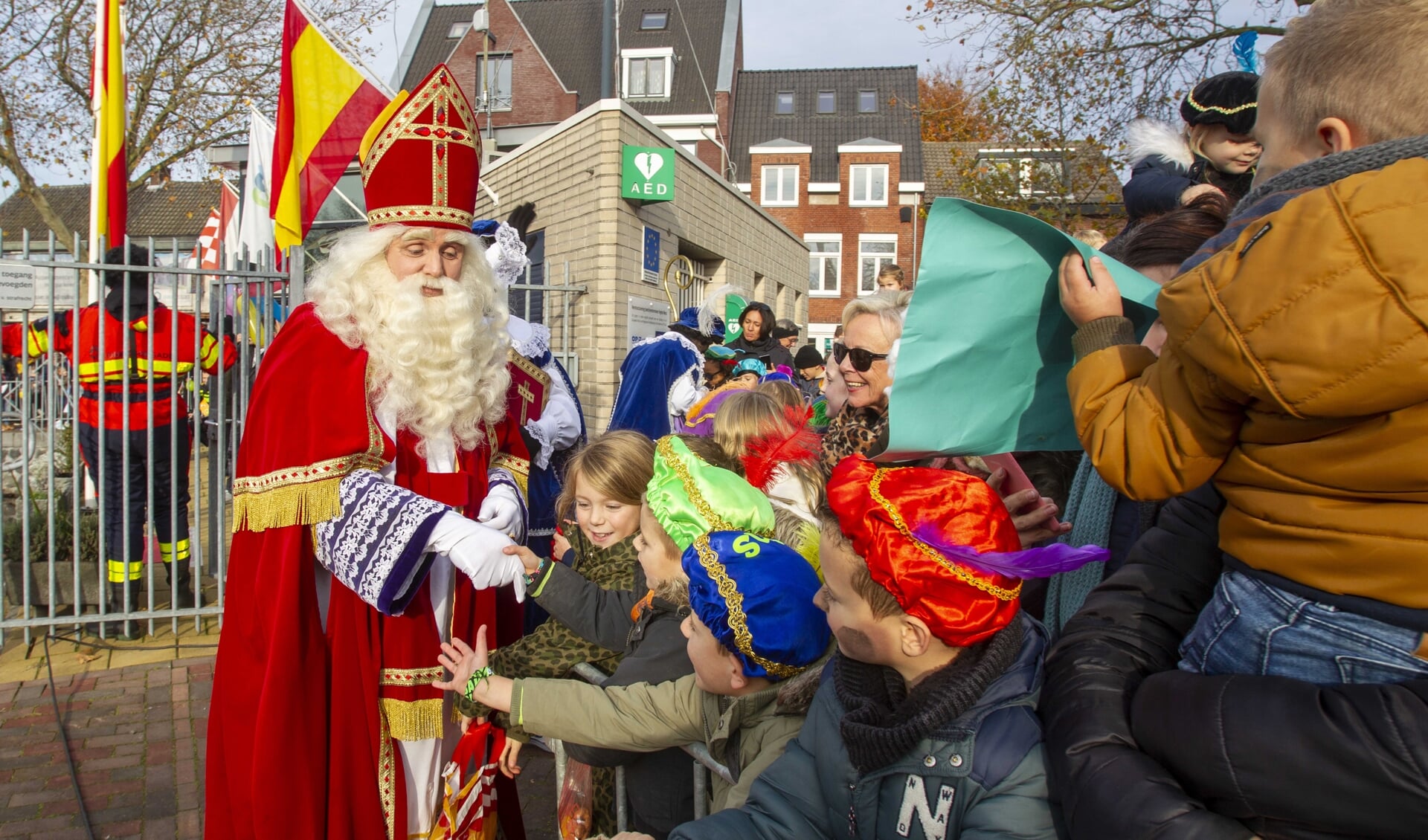 Sinterklaas schudt kinderhanden tijdens de intocht van vorig jaar.