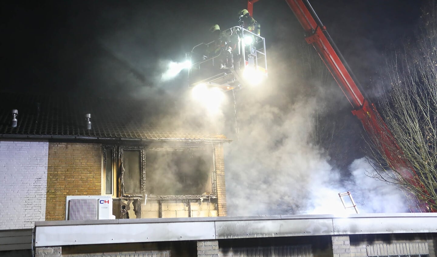 Autobrand slaat over op woning; jong gezin weet op tijd te vluchten. (Foto: Gabor Heeres / Foto Mallo)