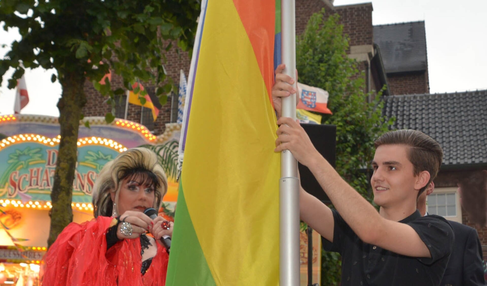 Tijdens Pink Friday op de kermis in Uden werd de regenboogvlag gehesen. Liz Richards, First Lady van de Mega Kermis Uden, nam samen met Simon van Ieperen de taak op zich. (foto: Henk Lunenburg)