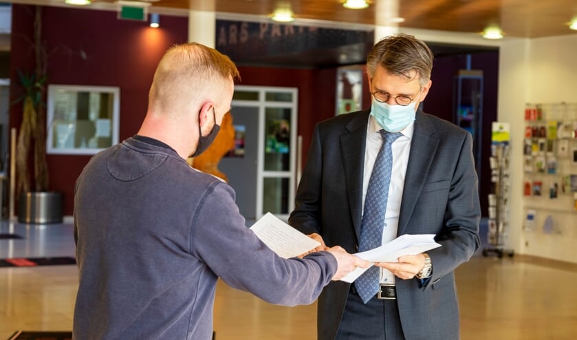 <p>Initiatiefnemer Marcel Peeters overhandigt de petitie 'Xhofleer moet blijven' aan burgemeester Hillenaar.</p>