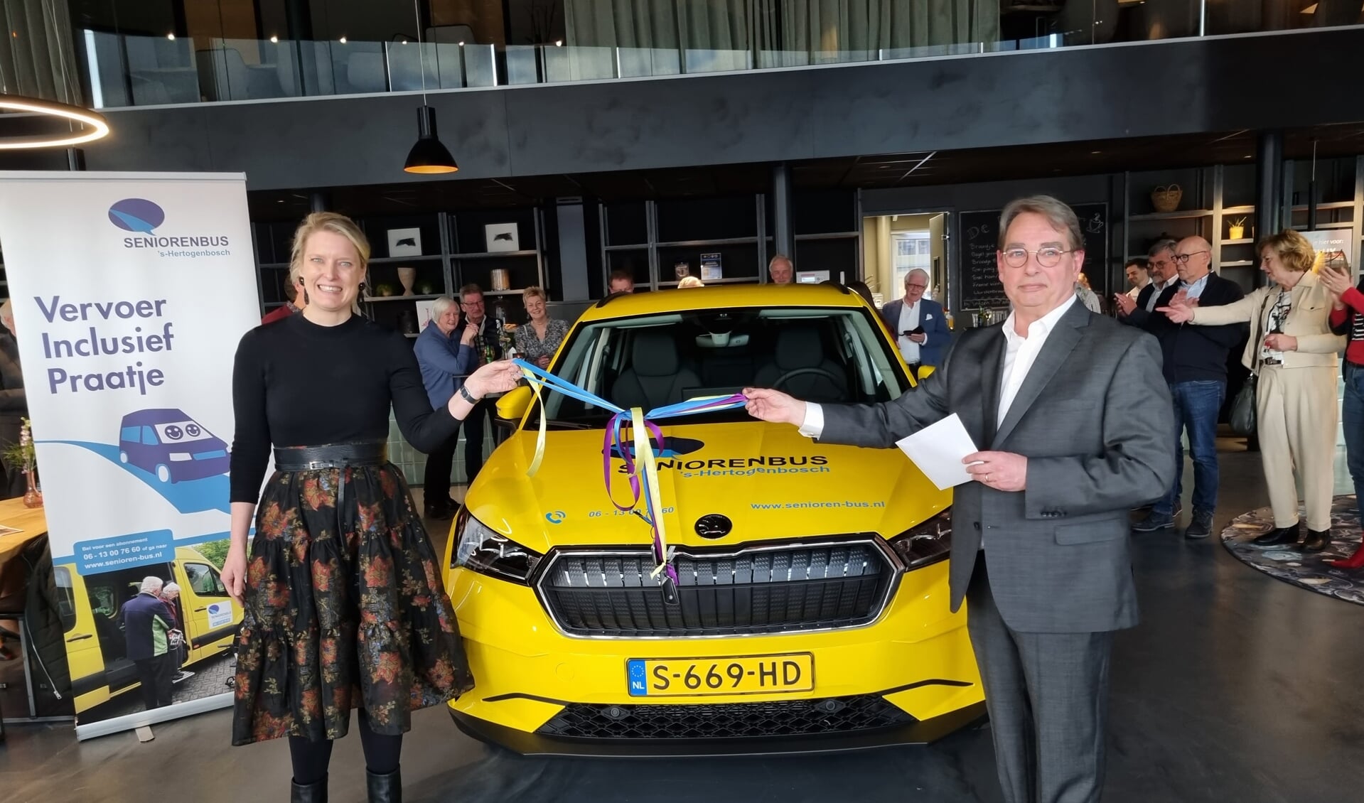 Wethouder Marianne van de Sloot overhandigt de sleutels van drie nieuwe elektrische auto’s aan de voorzitter van Stichting Seniorenbus ‘s-Hertogenbosch Rob van Bergen.