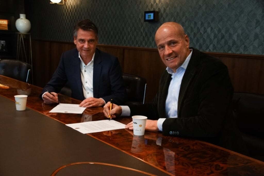 Edwin van den Boom (L) en Frits van Eerd (R) ondertekenen het contract.
