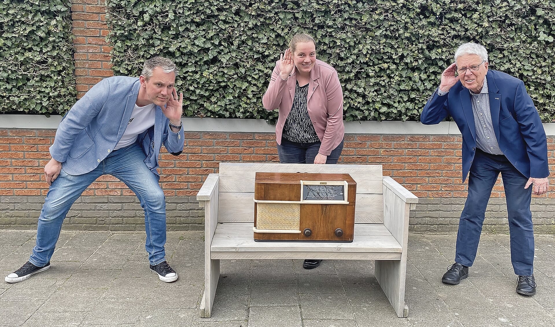 Mark te Poele, Nynke Vergeer en Kees Bazuine met de oude radio uit oorlogstijd, een van de gebruikte voorwerpen die terugkomen in de speurtocht.
