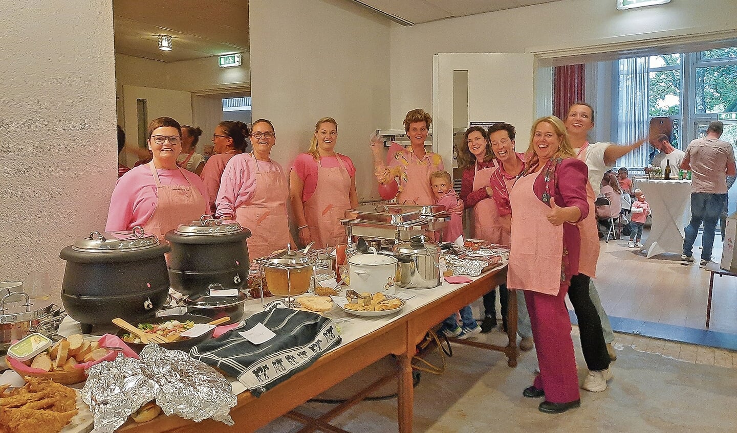 Het achtkoppige (roze) organisatieteam ziet een mooi gevuld buffet.