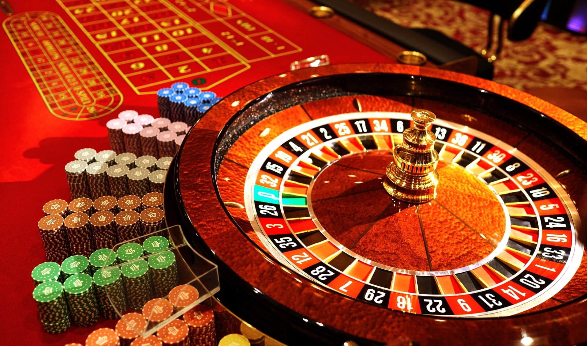 Roulette at the casino. The table is red for playing roulette.