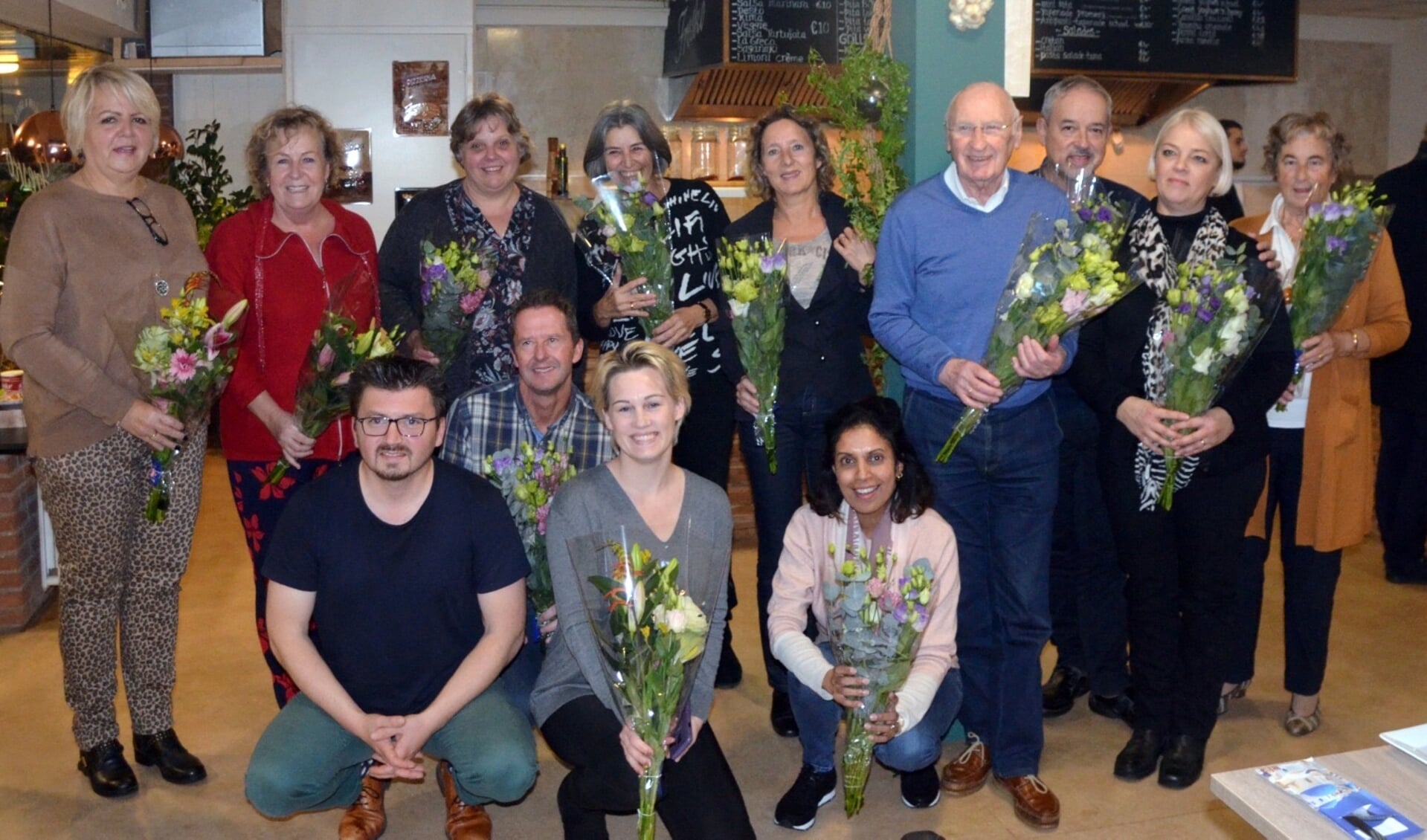 De tien mantelzorgers en Betty, Sunita en Nine van De Toekomst. Tweede van links staand Betty Guys en eerste van links zittend Cengiz Tutar, voorzitter van PvdA Barendrecht.