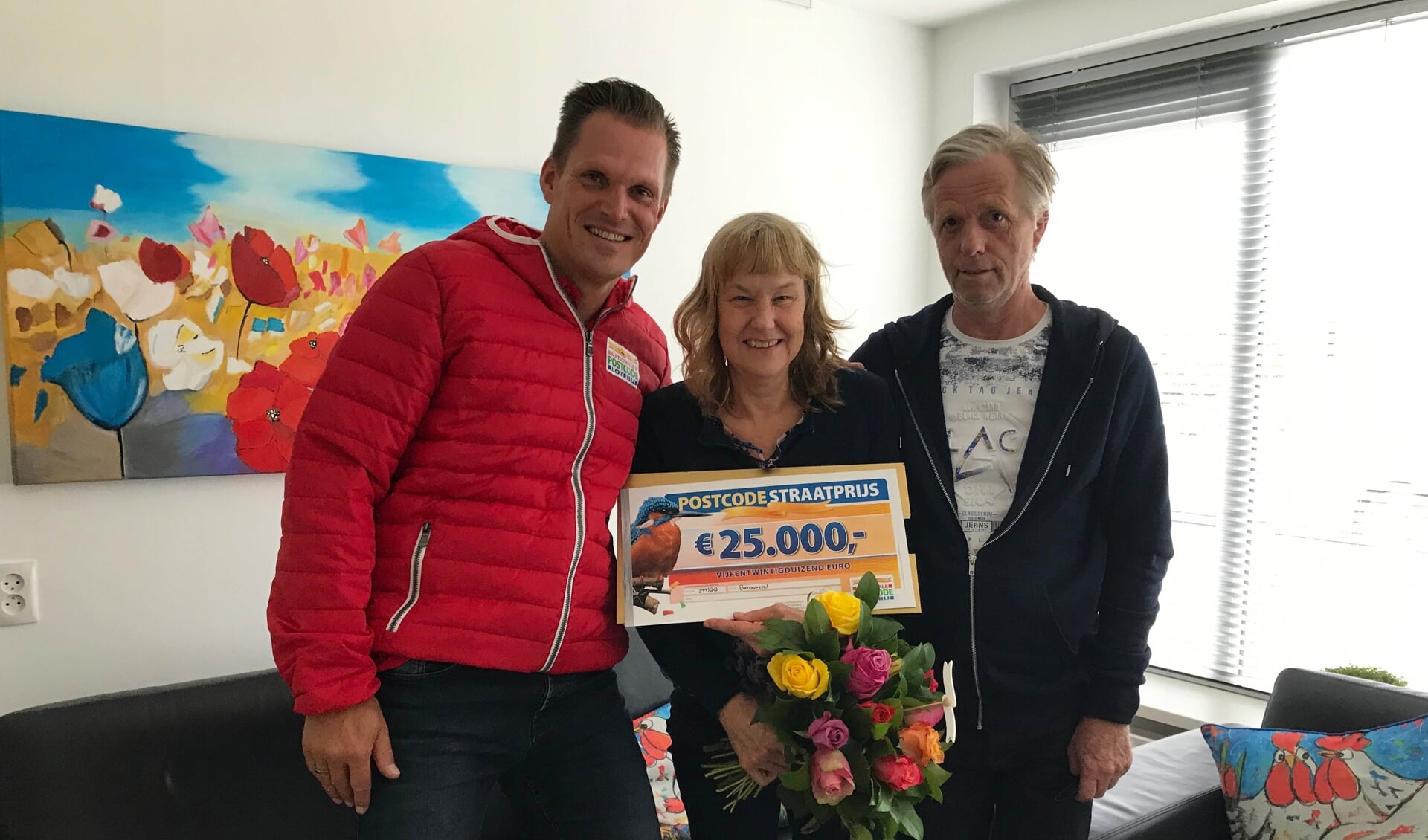 Piet en zijn vrouw uit Barendrecht worden verrast door de Postcode Loterij met de PostcodeStraatprijs-cheque.