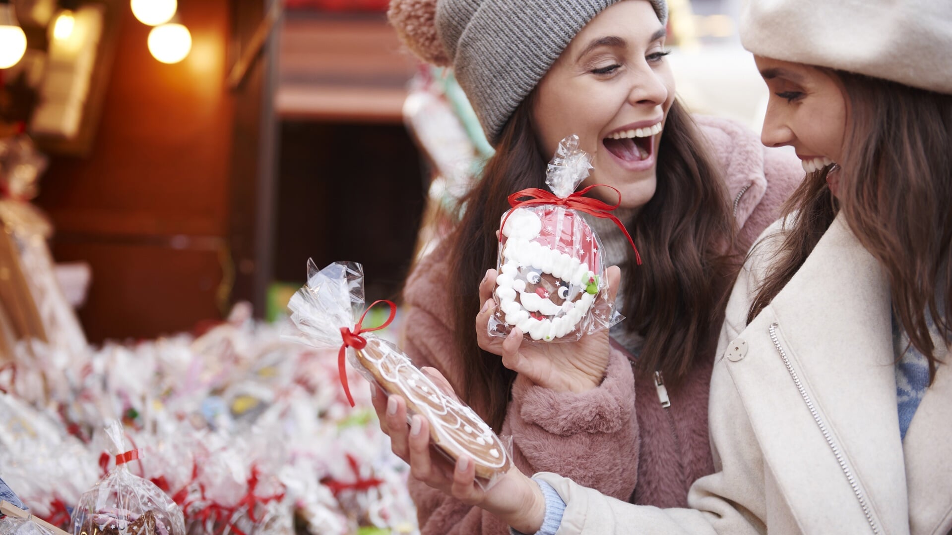 Two women buying ginger breads on Christmas market
