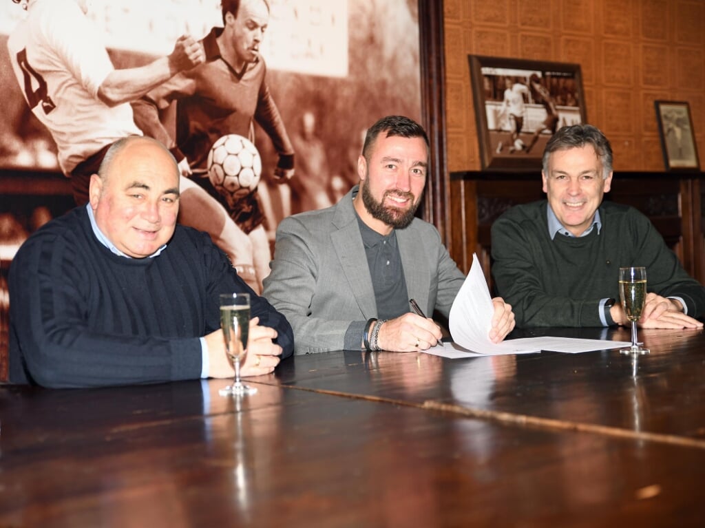 Leen van Steensel (midden) tekent het contract.