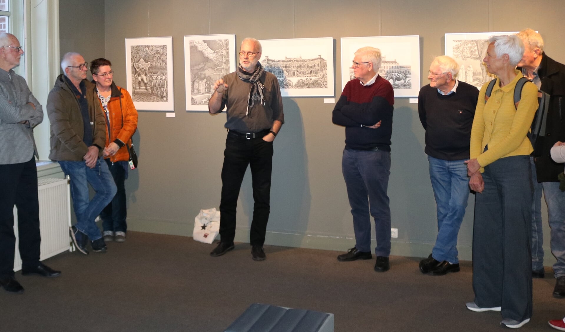 Kunstenaar Jan Vosman (midden) geeft uitleg bij zijn werk. Uiterst links zijn leermeester, kunstenaar Henk Blokhuis, die de expositie opende. 
