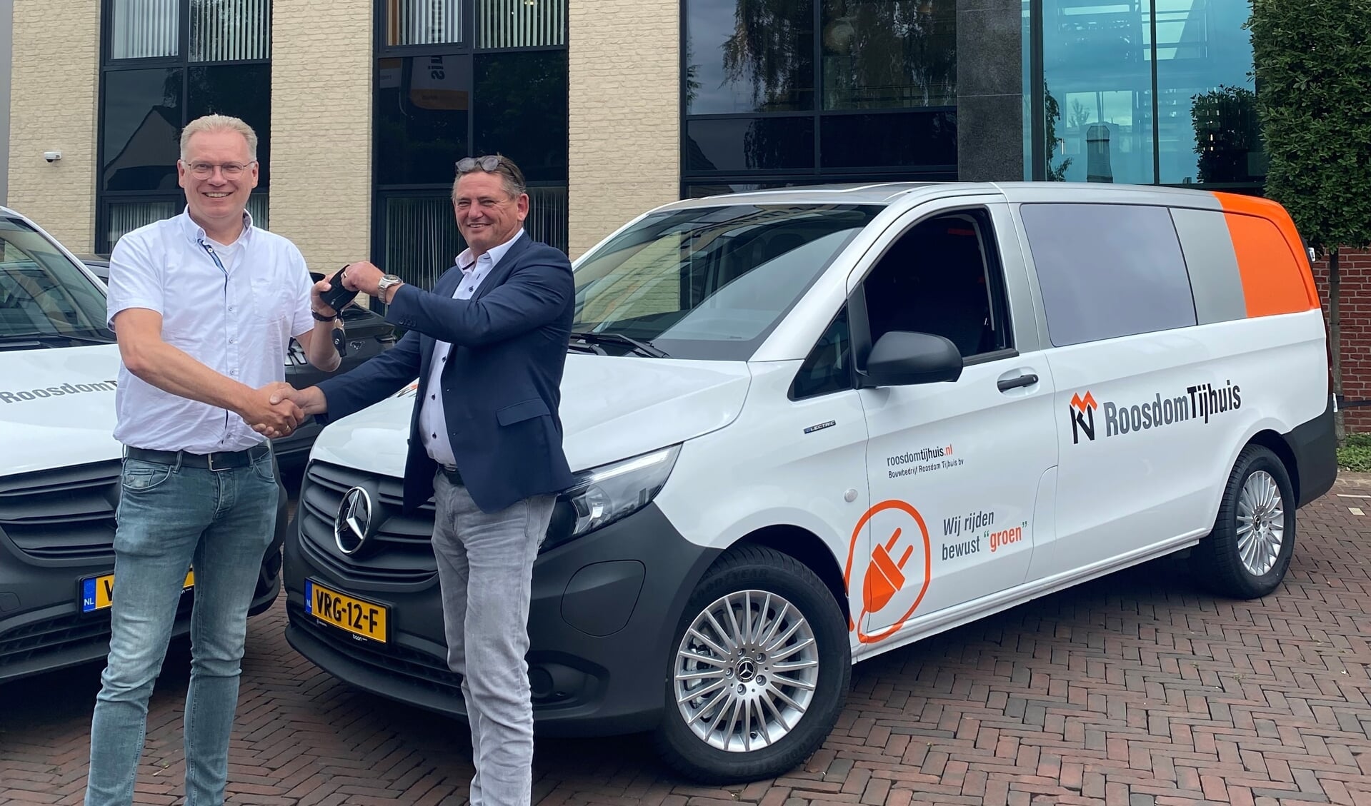Joop Jansen, adjunct-directeur Roosdom Tijhuis (links) ontvangt de autosleutels van Henk Wessels, verkoopadviseur bedrijfswagens Baan Twente.