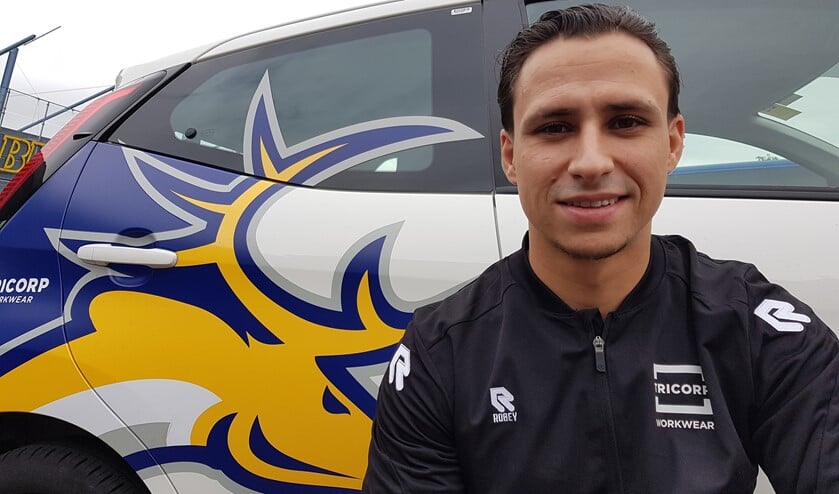 Raymond van der Schuit bij de auto van de club, met het geel-blauwe logo van de Tilburg Trappers. Foto: Emile Hilgers
