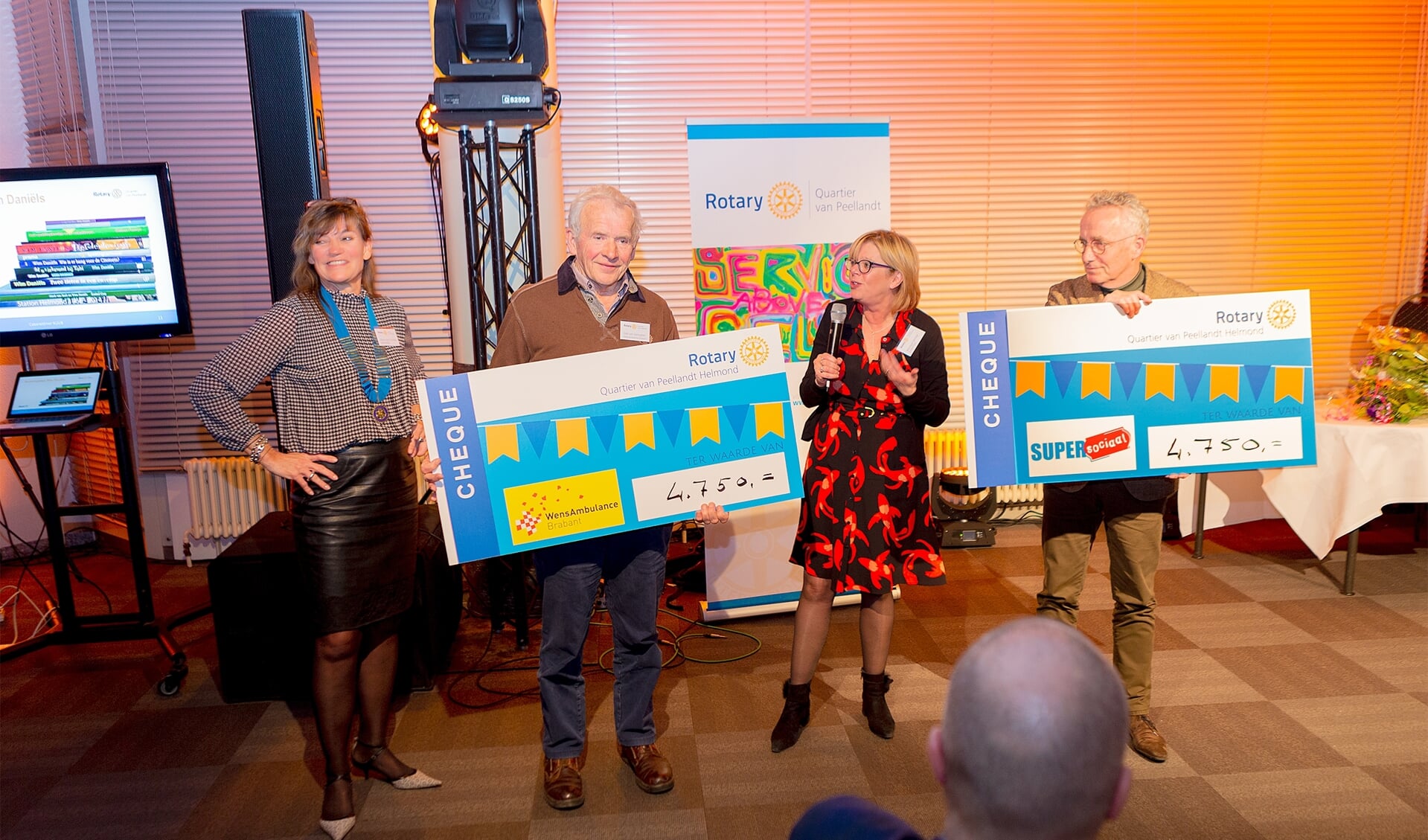 Giel van Genuchten (Stg. Wensambulance Brabant) en Joop van Stiphout (SuperSociaal) nemen de cheques in ontvangst van Rotary Quartier van Peellandt