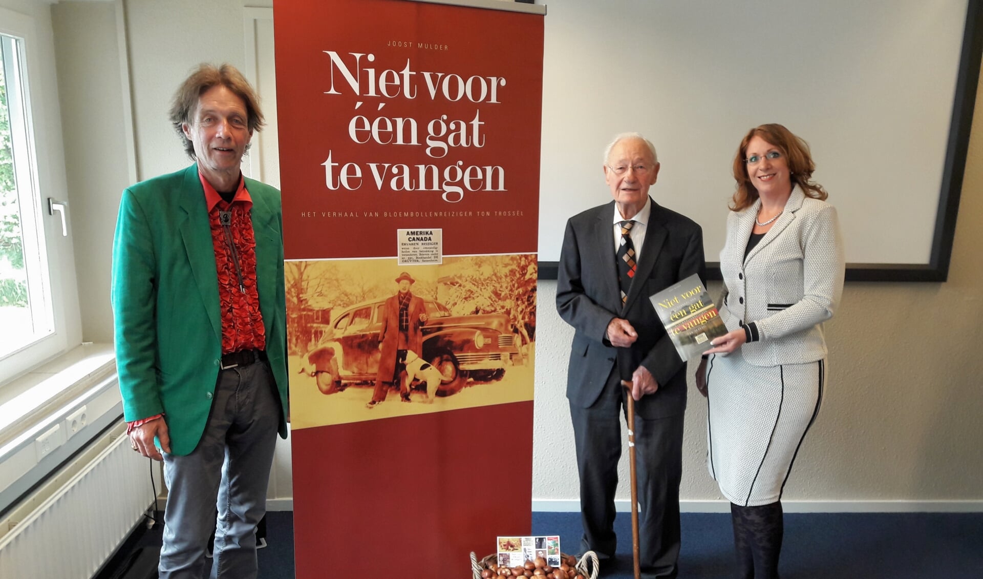 Burgemeester Carla Breuer ontvangt het eerste boek uit handen van Ton Trossèl en schrijver Joost Mulder (r). | Foto: MV