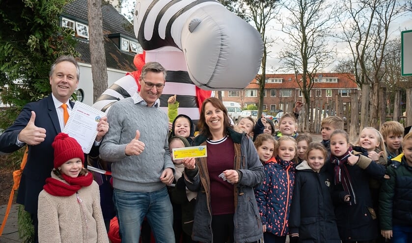 Wethouder Willem Joosten (geheel links) met locatieleider Maarten Meijers en juf Arnica Geertsema en een aantal kinderen van groep 5 bij zebra Seef, de mascotte van School op Seef. | Foto: J.P. Kranenburg